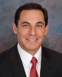 : Photograph of Dr. Luis Tumialan, a Phoenix-based neurosurgeon specialized in spine surgery and the treatment of complex spine tumors and disorders.