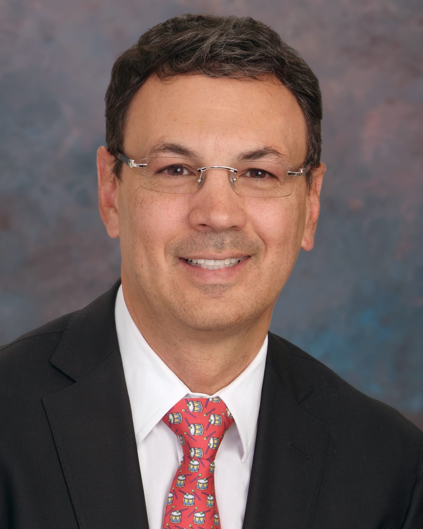 Photograph of Dr. Juan Uribe, MD, an Arizona-based neurosurgeon specialized in minimally invasive spine surgery and spine tumor treatment.